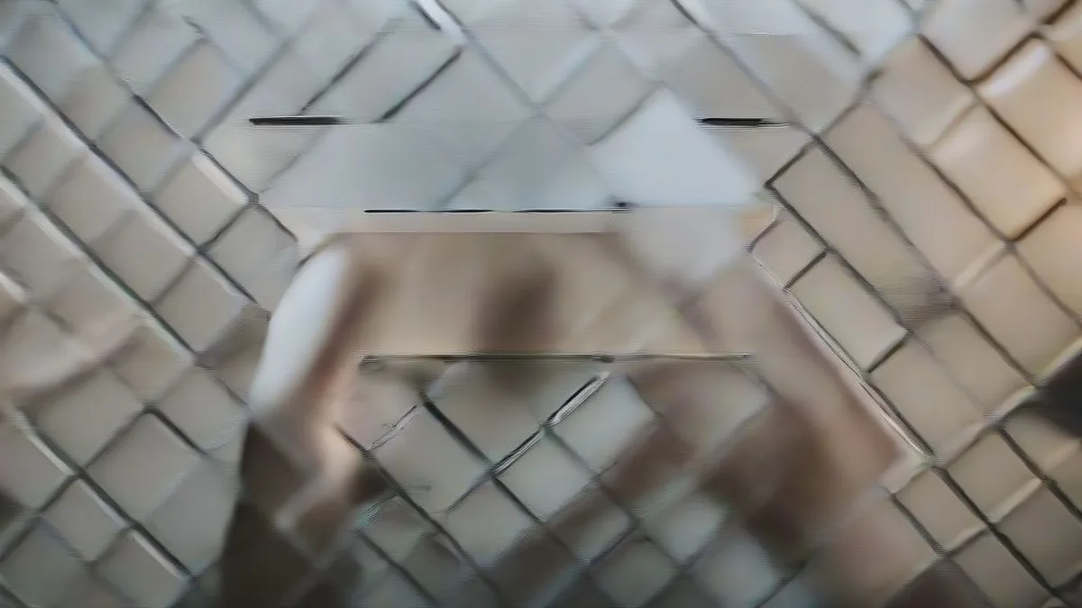 A close-up of a person holding an unfolded foldable smartphone in a retail environment.