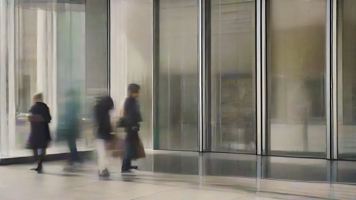 People waiting in a queue outside a modern retail store for a product launch.