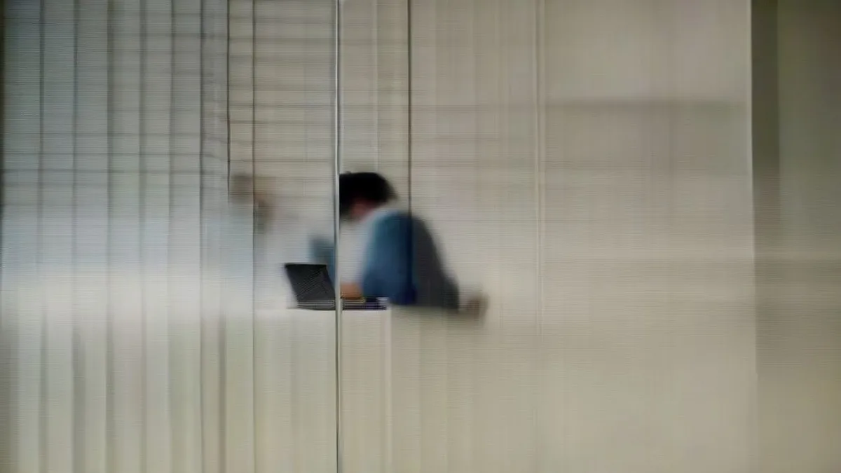 A person using a laptop to apply for government teacher recruitment