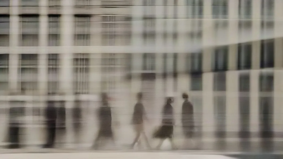 Pedestrians walking on a hot sunny city street