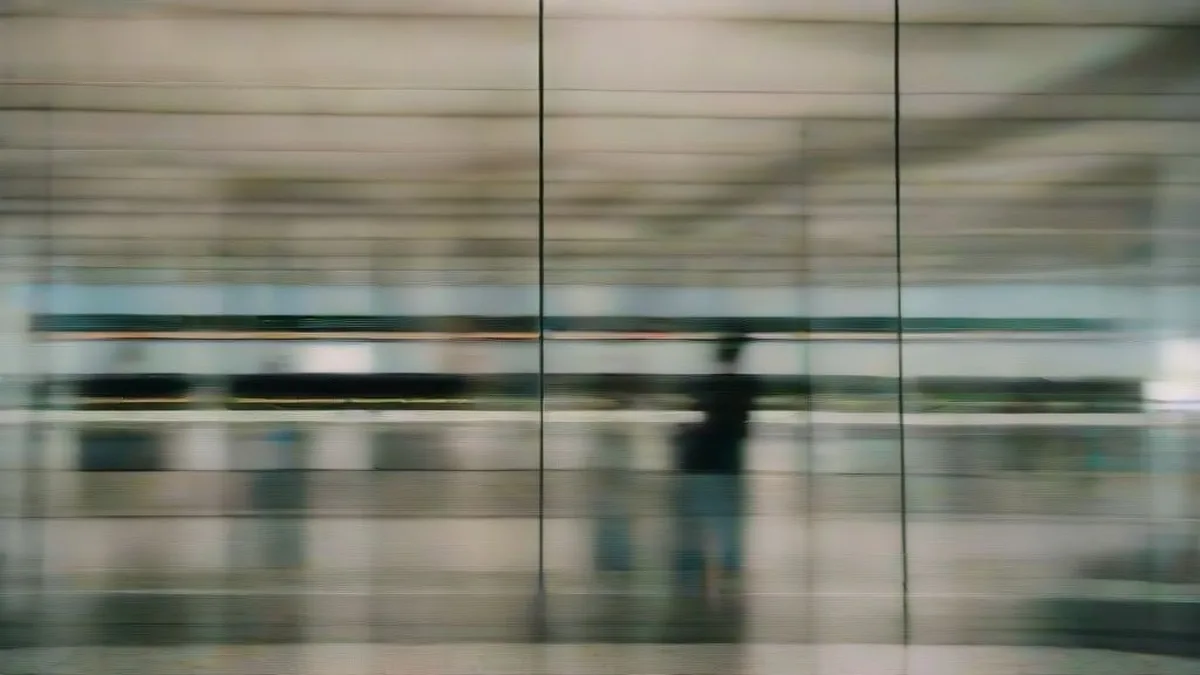 Passengers looking at flight cancellation boards inside an airport terminal during Cyclone Arnab