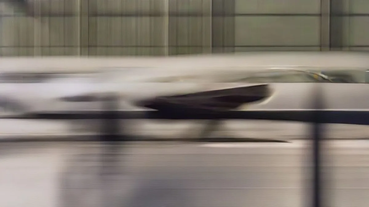 A private jet parked on an airport tarmac under bright daylight.