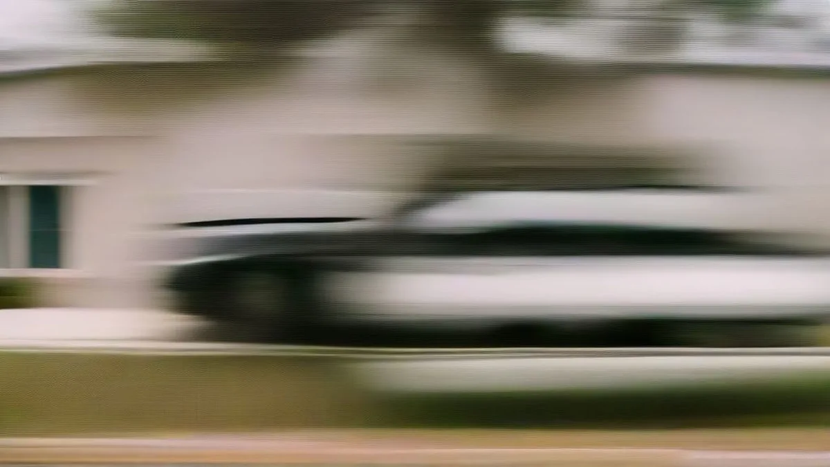 Police vehicles parked outside a suburban home during a law enforcement investigation.