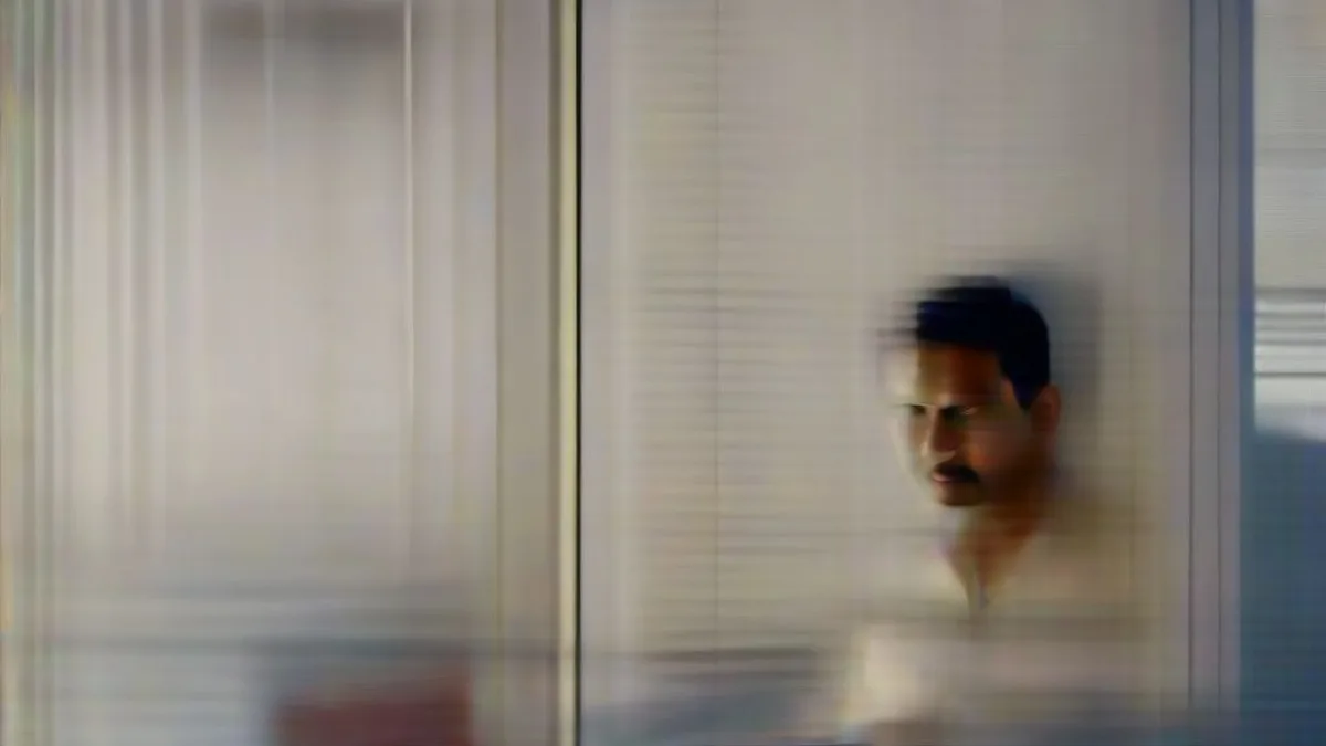 A software engineer working on data analytics and AI systems on multiple monitors in a modern office.