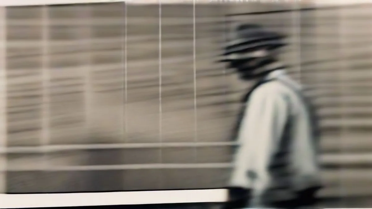 A railway official looking at train operations on a station platform.