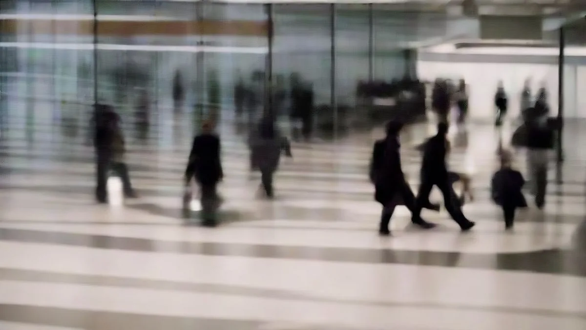 Travelers walking through an international airport terminal corridor