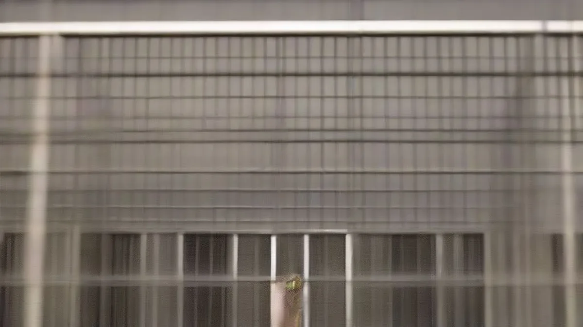 Police personnel stationed outside high-security prison gates