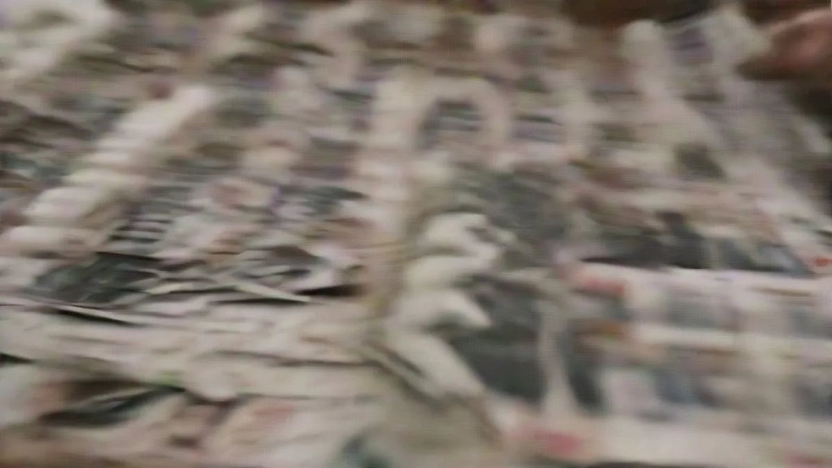 Police and revenue officials examining abandoned voter ID cards recovered from the Narmada riverbank.