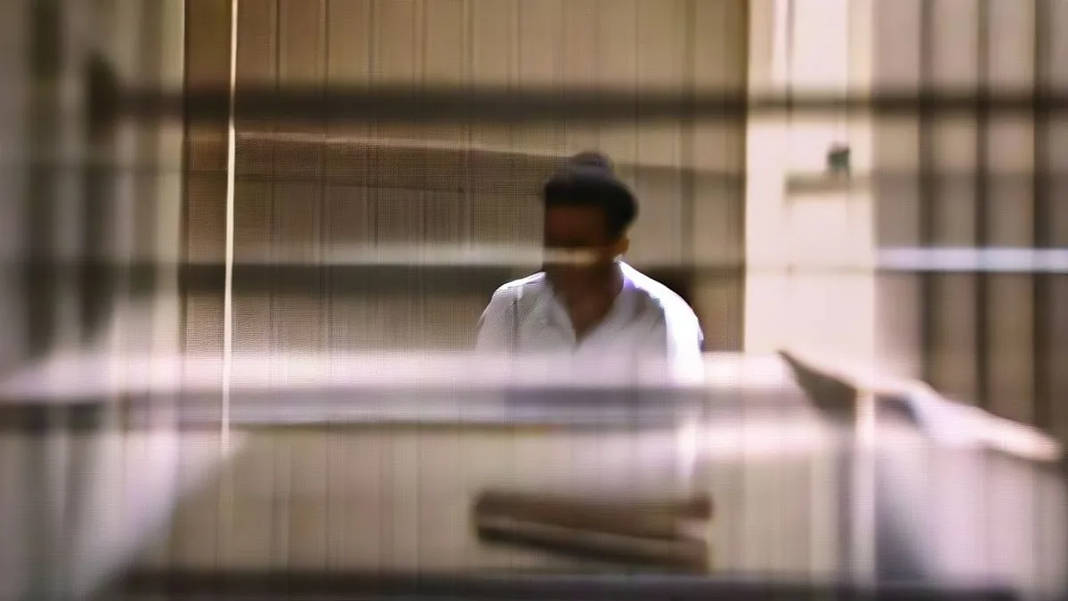 An inmate writing a book inside a Tamil Nadu prison cell