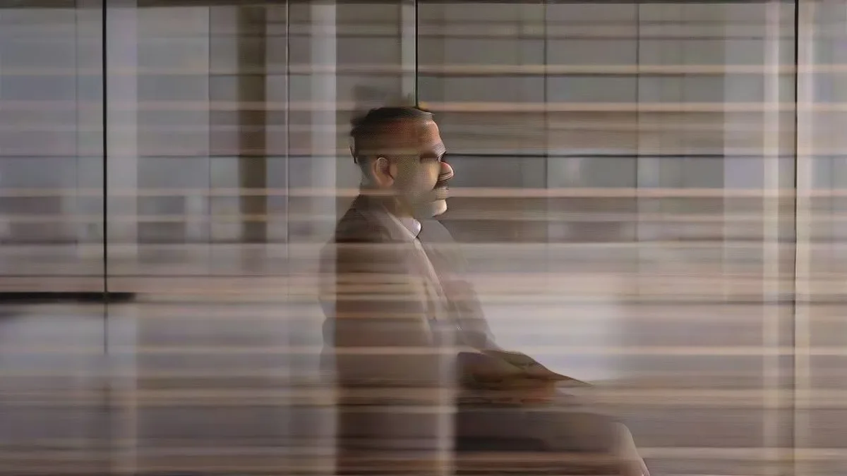 Sridhar Vembu in a modern office setting reflecting on AI and society.