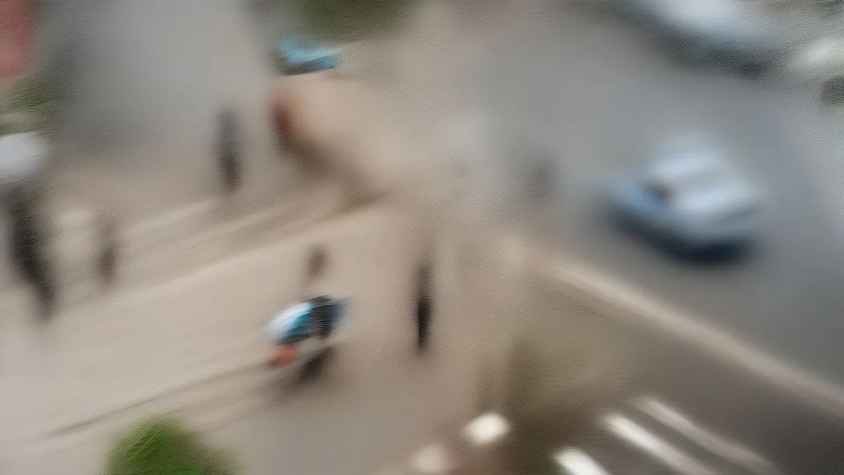 Urban street intersection in Hyderabad with police officers and traffic during the day.