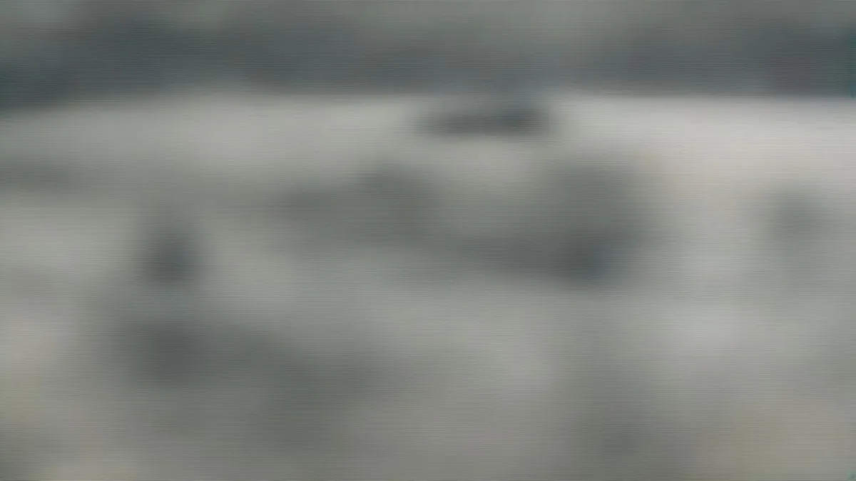 Wide shot of a Canadian military base training ground under an overcast sky with tactical vehicles.